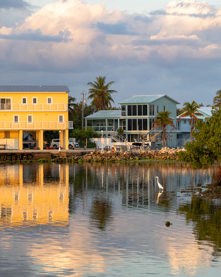Waterfront homes reflected in a calm canal