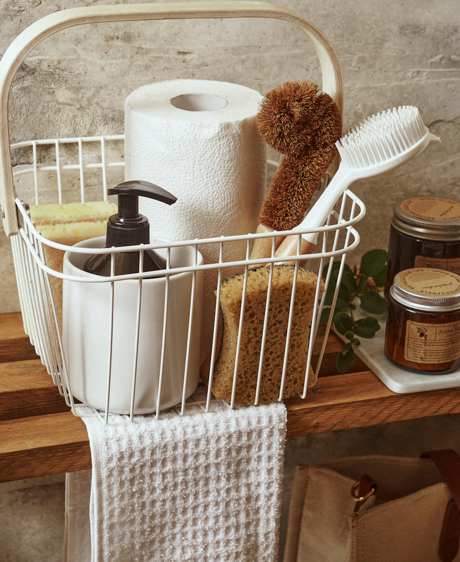 A basket of cleaning supplies and towels